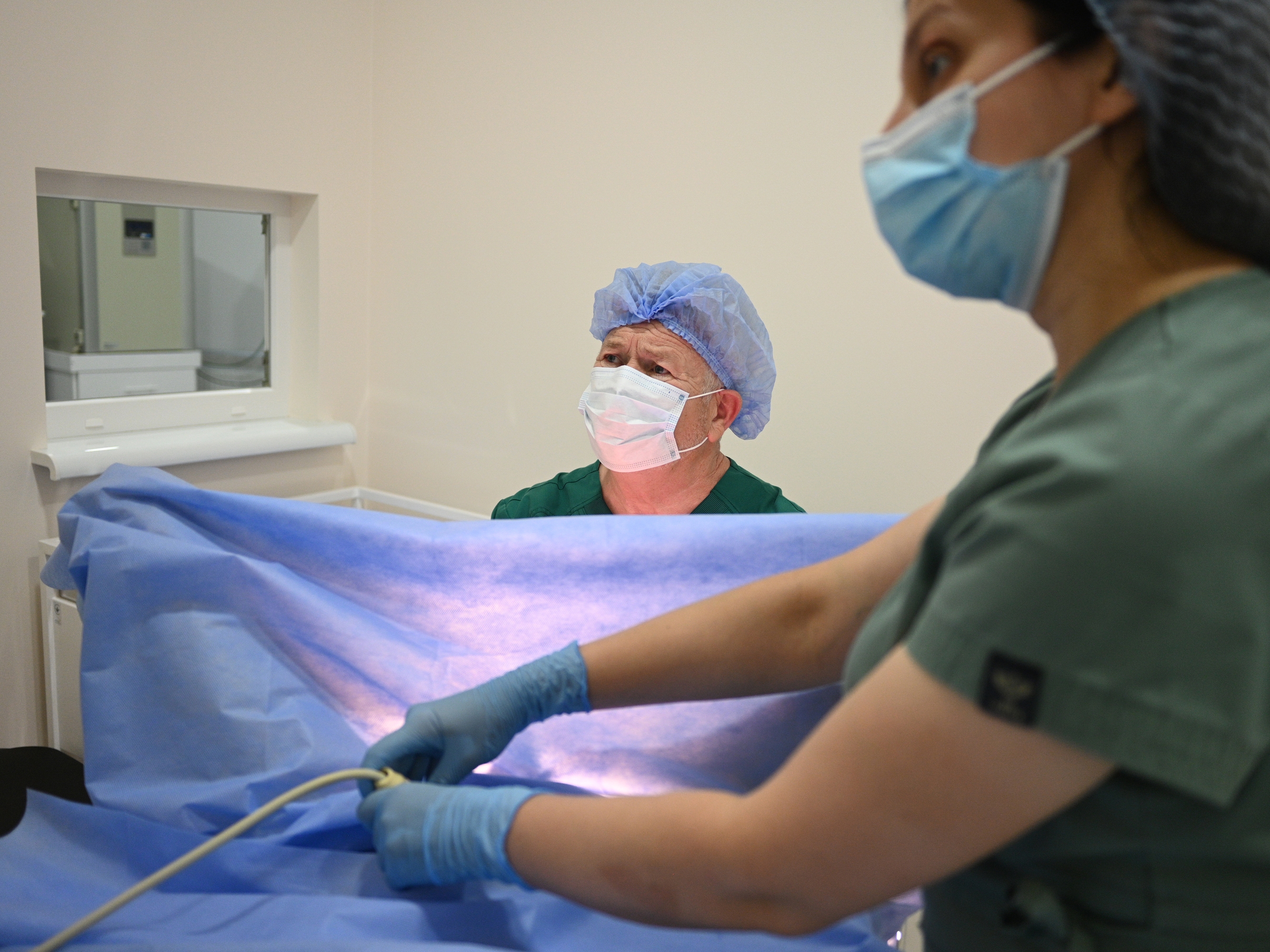 caption: Dr. Stefan Khmil performs artificial insemination on a patient in his Clinic of Prof. Stefan Khmil in Ternopil, Ukraine, on July 12.