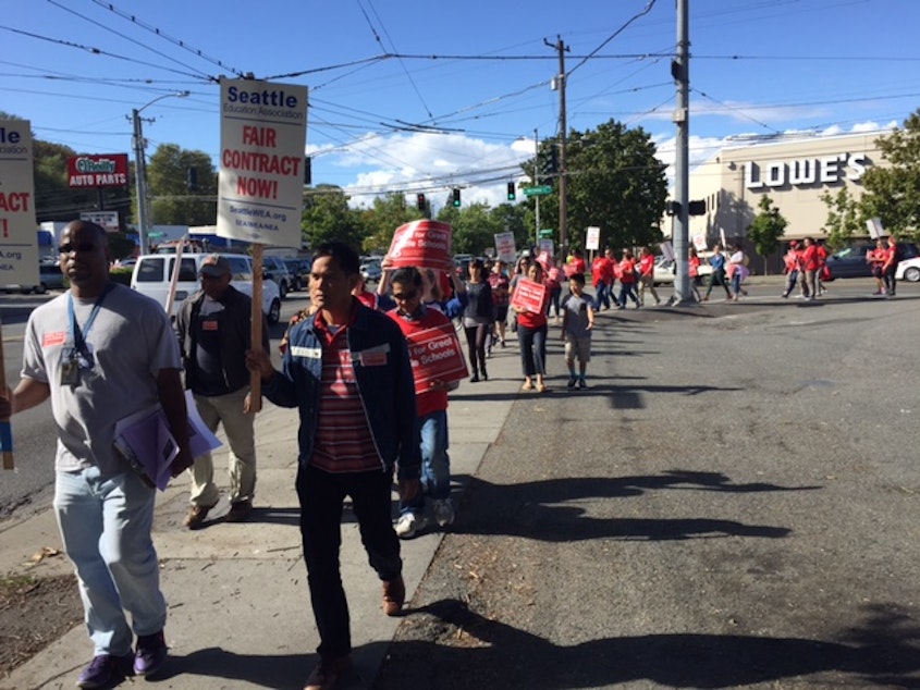 caption: Teachers donned red shirts and picketed outside schools across Seattle on Wednesday. They will vote on whether to strike on Thursday evening. 
