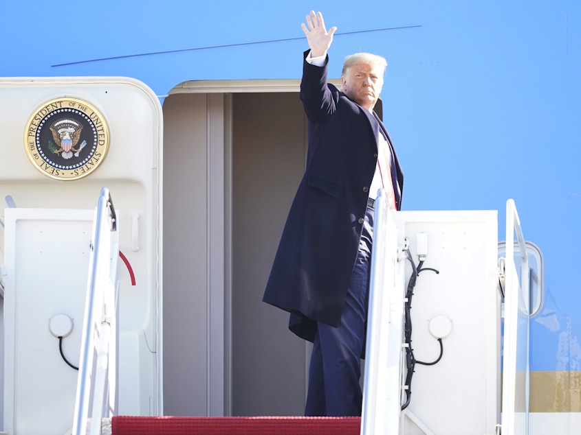 caption: President Donald Trump waves while boarding Air Force One at Joint Base Andrews before a Jan. 12 trip to Texas. He's planning a departure ceremony there on Wednesday, while skipping the traditional send-off at the Capitol.