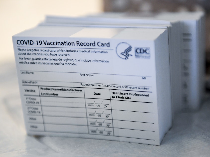 caption: A stack of COVID-19 vaccination record cards from the Centers for Disease Control and Prevention. They provide proof that you've had your shot — but aren't exactly wallet size at 4 by 3 inches.