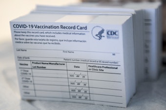 caption: A stack of COVID-19 vaccination record cards from the Centers for Disease Control and Prevention. They provide proof that you've had your shot — but aren't exactly wallet size at 4 by 3 inches.