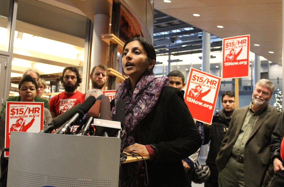 caption: Newly-elected Socialist City Councilmember Kshama Sawant speaks at a city hall press conference on the $15 an hour minimum wage.