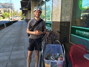 caption: Seattle Food Rescue founder Tim Jenkins picks up food from Stock Box on James St.