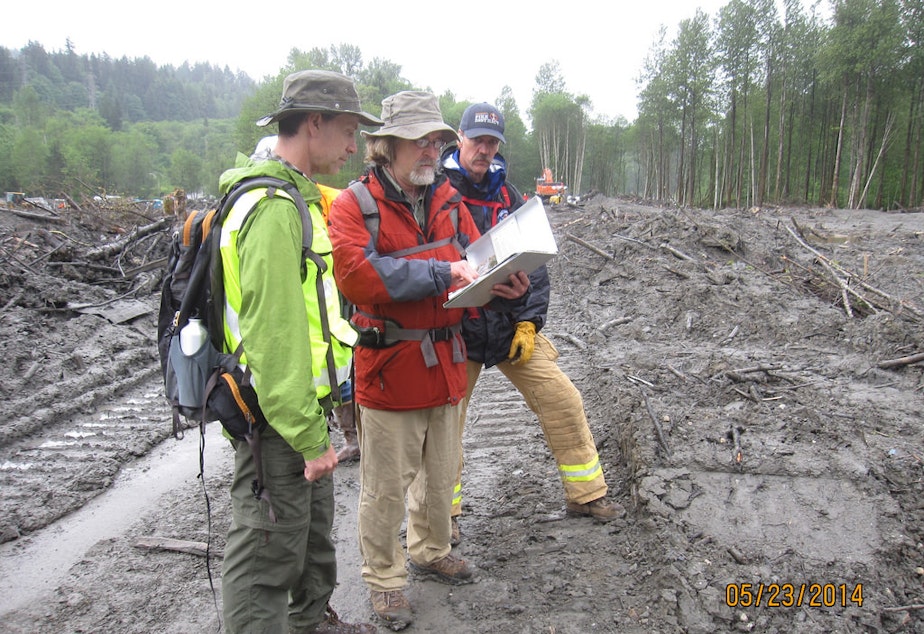 caption: Reviewing their field notes on observations made during the Geotechnical Extreme Events Reconnaissance investigation of the 2014 Oso Landslide are Civil & Environmental Engineering Associate Professor Joe Wartman and Earth & Space Sciences Professor Dave Montgomery. Photo taken in April 2014.
