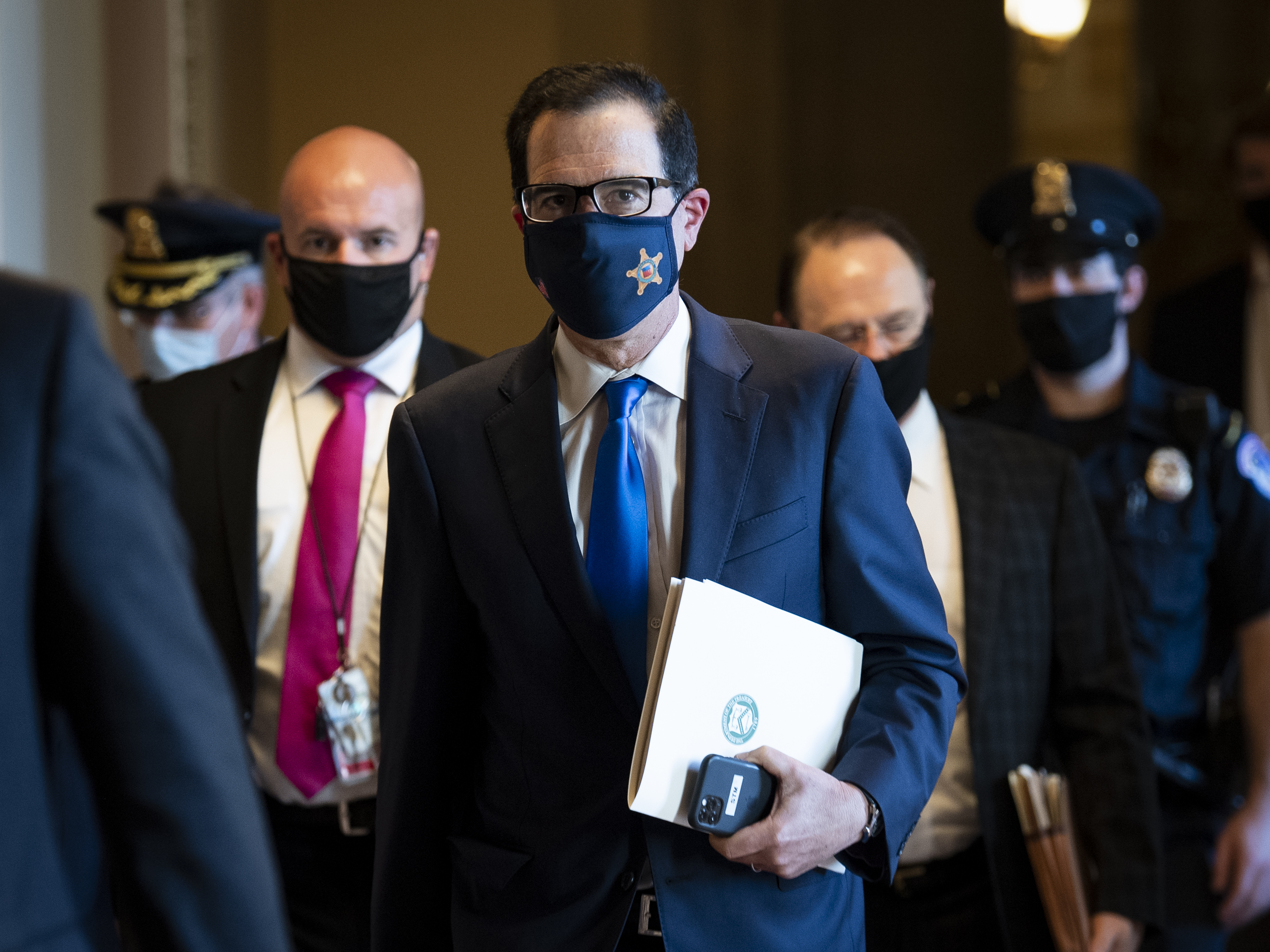 caption: Treasury Secretary Steven Mnuchin departs from the office of Senate Majority Leader Mitch McConnell on September 30. Mnuchin is one of the people who had contact with President Trump in the past week and was subsequently tested for coronavirus and reported a negative result.
