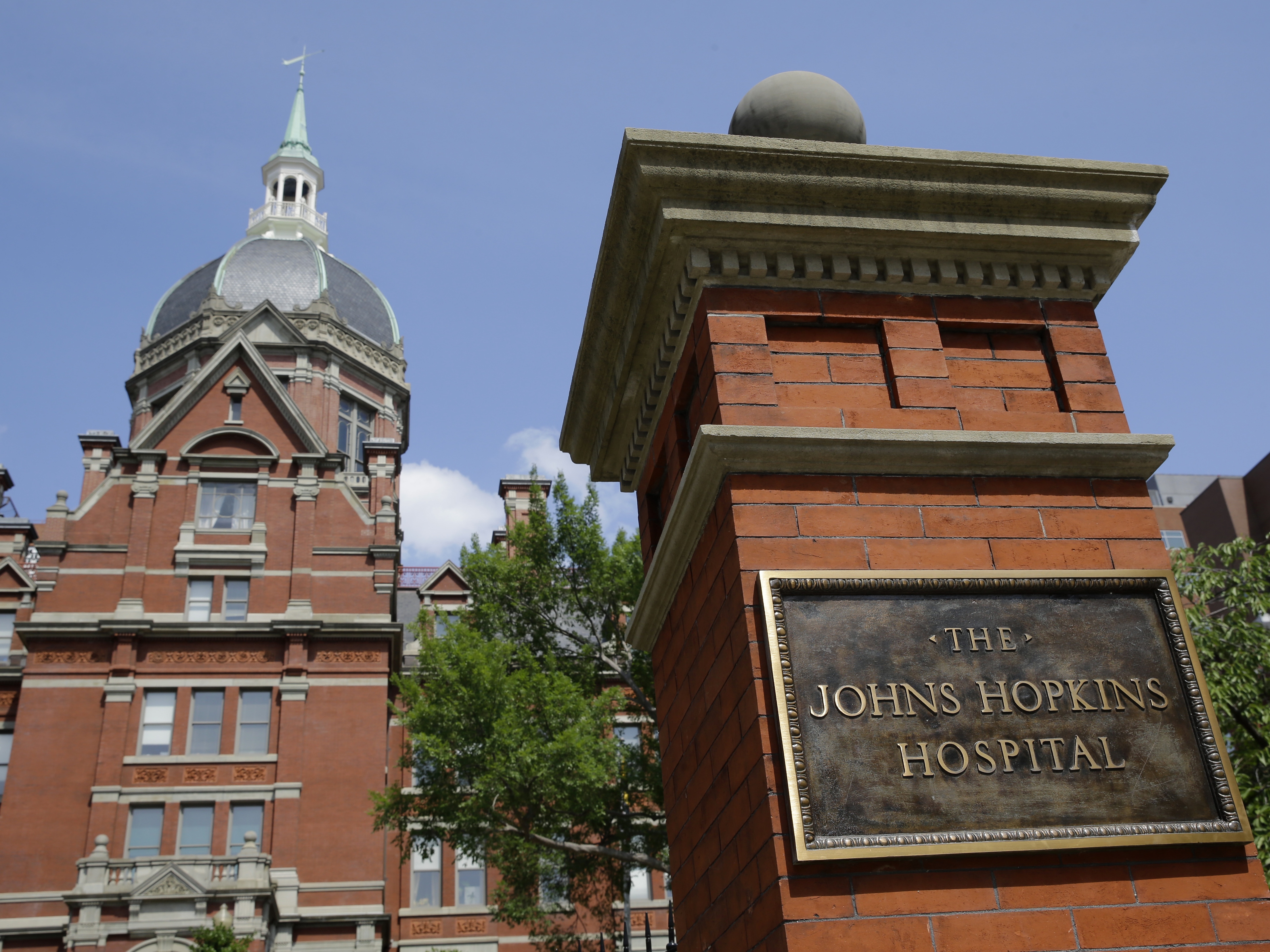 caption: A sign stands in front of part of the Johns Hopkins Hospital complex in Baltimore.