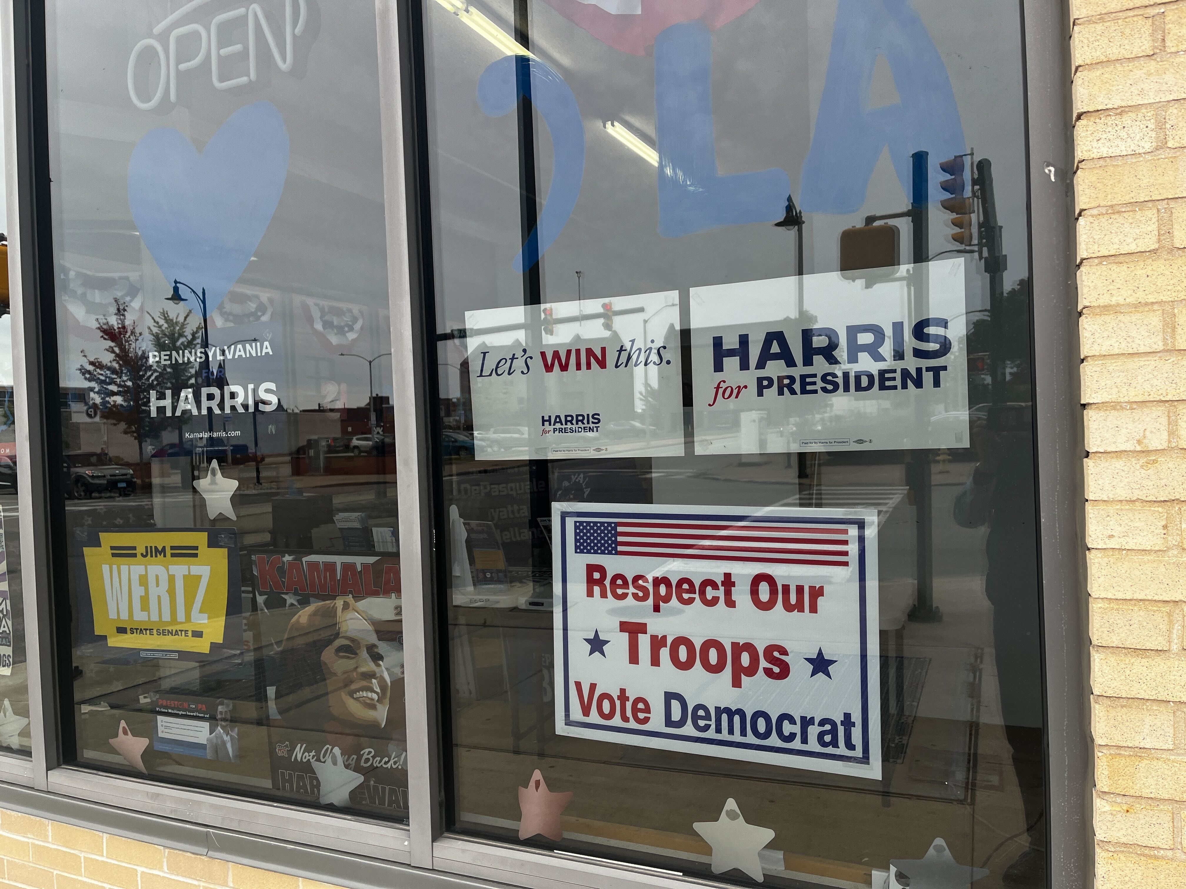 caption: Campaign signs are seen in windows of the Erie County Democratic Party headquarters.