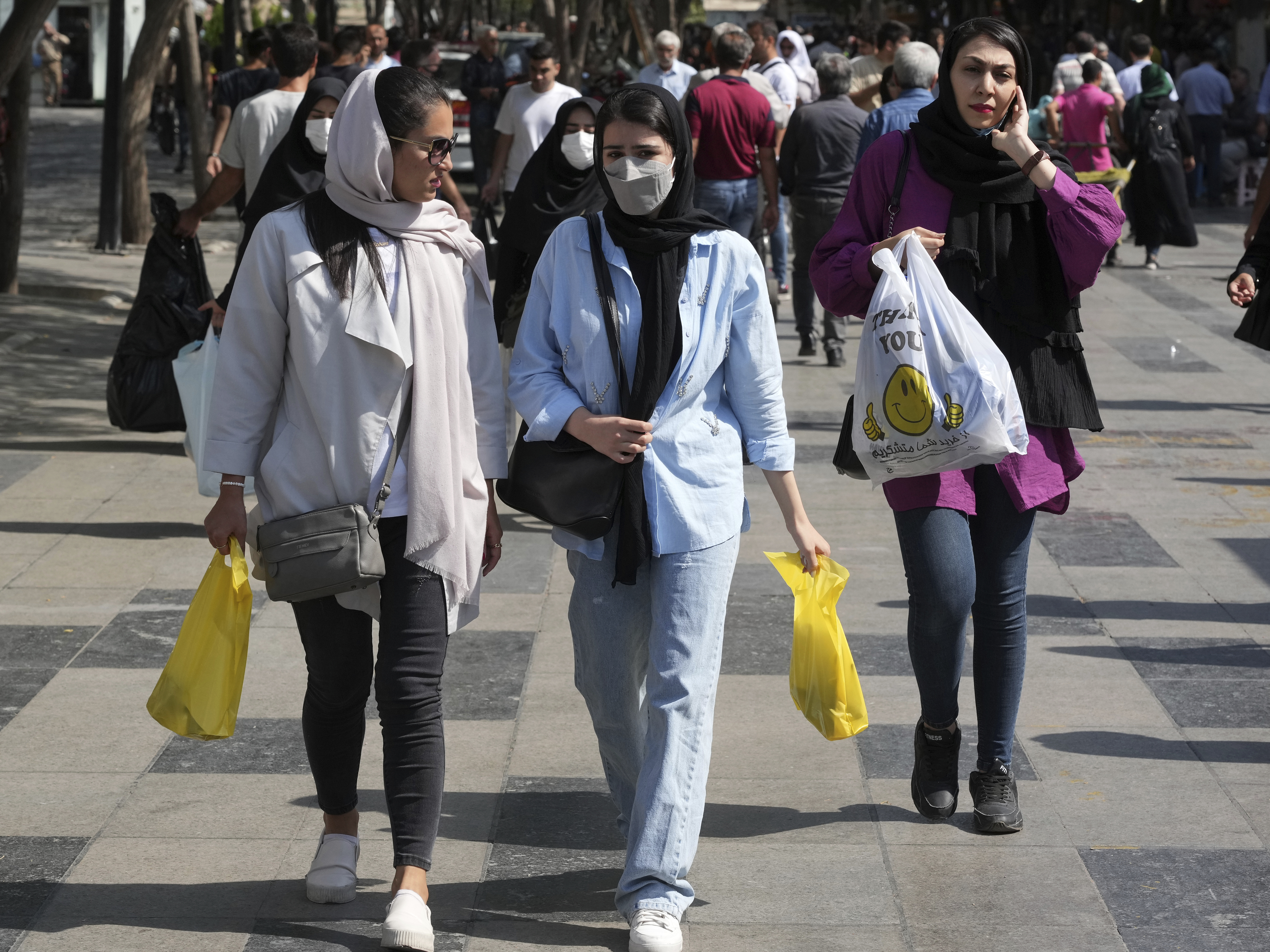 caption: Women shop in the old main bazaar of Tehran, Iran, in October 2022. Iranian police have announced a new campaign to force women to wear the Islamic headscarf.