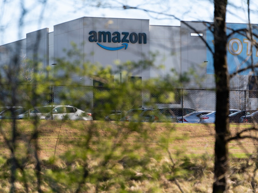 caption: The Amazon warehouse at the center of a high-profile unionization drive is seen on March 29 in Bessemer, Alabama.