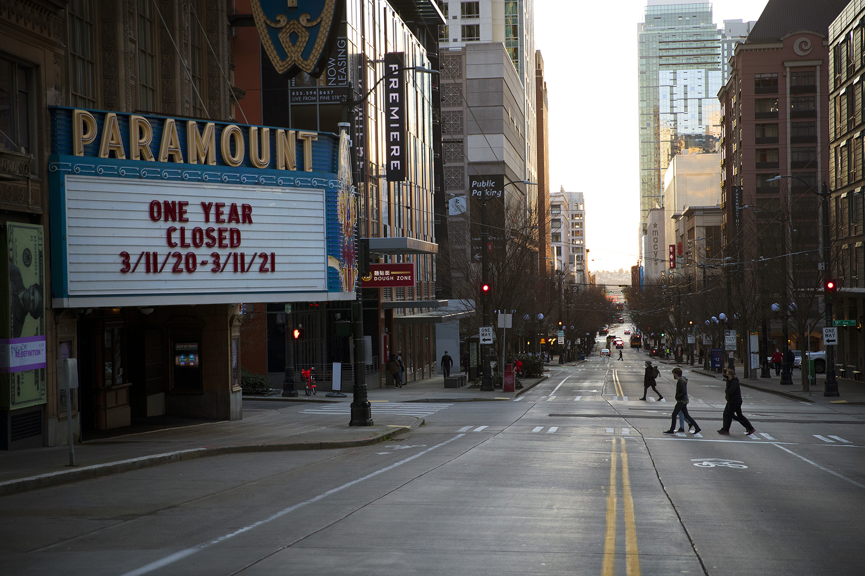 caption: The Paramount Theatre marquee reads 'One Year Closed 3/11/20 - 3/11/21,' as the sun sets on Thursday, March 11, 2021, along Pine Street in Seattle. 