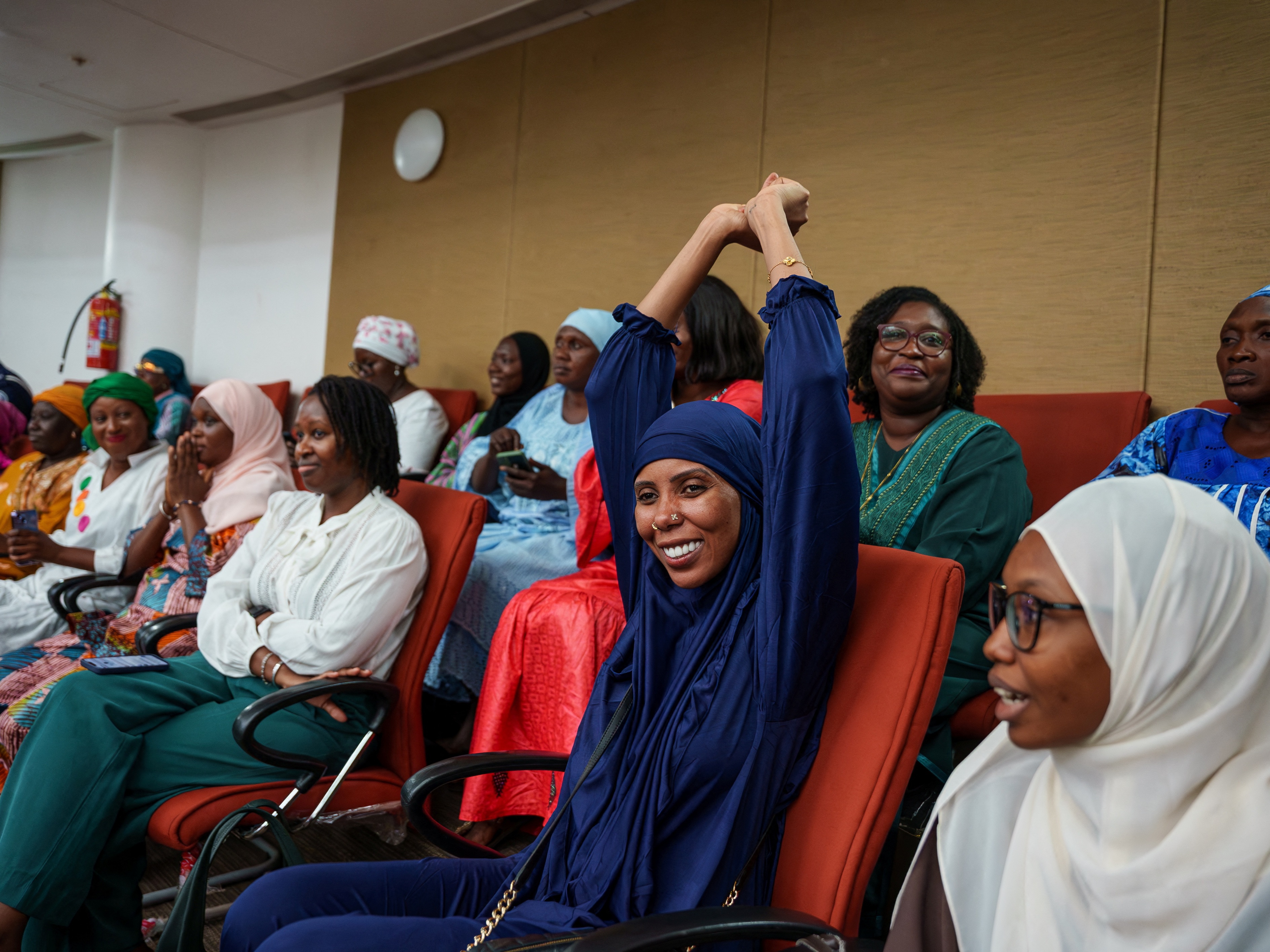 caption: Gambian activist Jaha Dukureh celebrates after the country's parliament rejected the bill to end a ban on female genital mutilation.