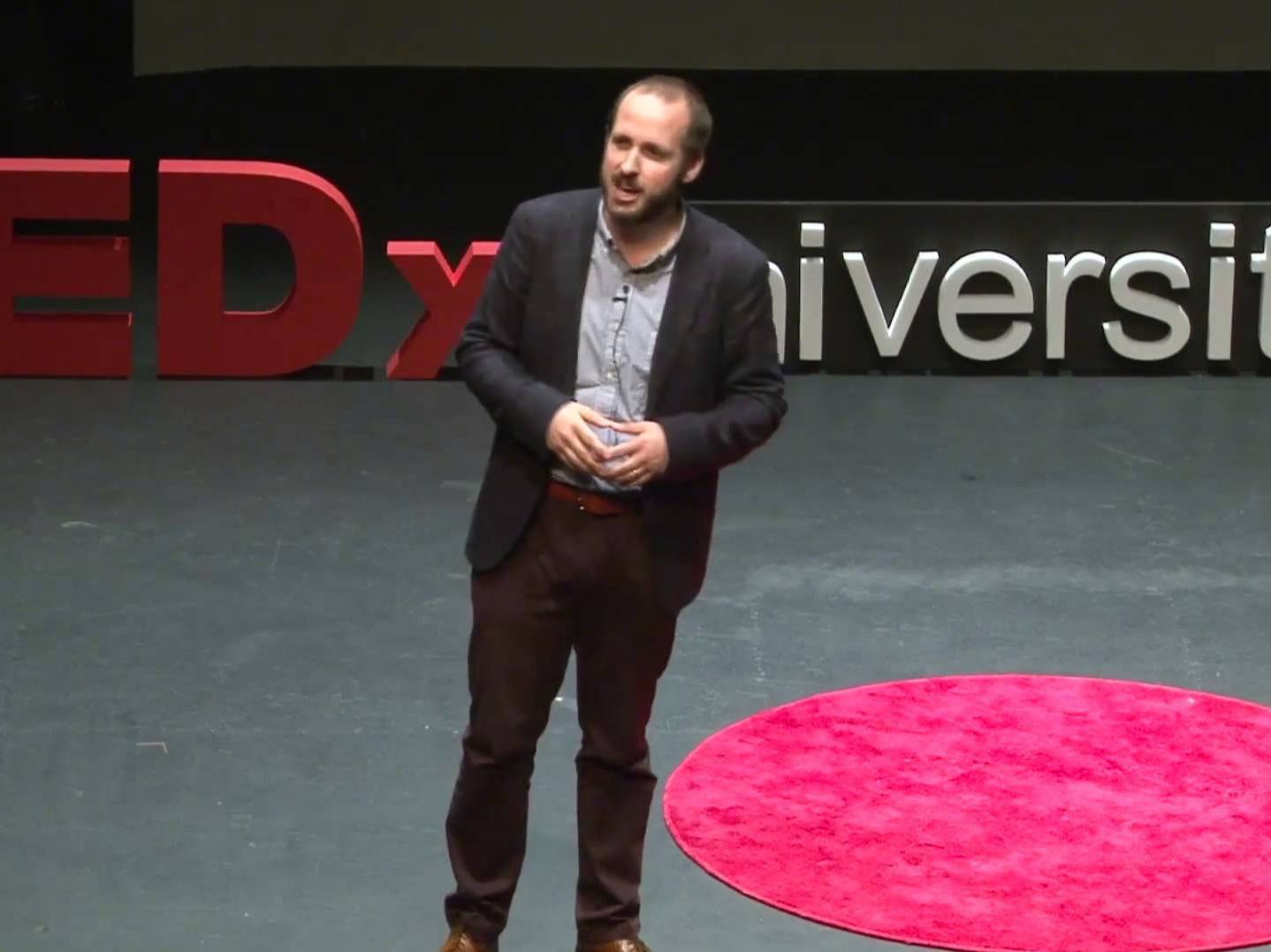 caption: Jeffrey Howard on the TED stage.