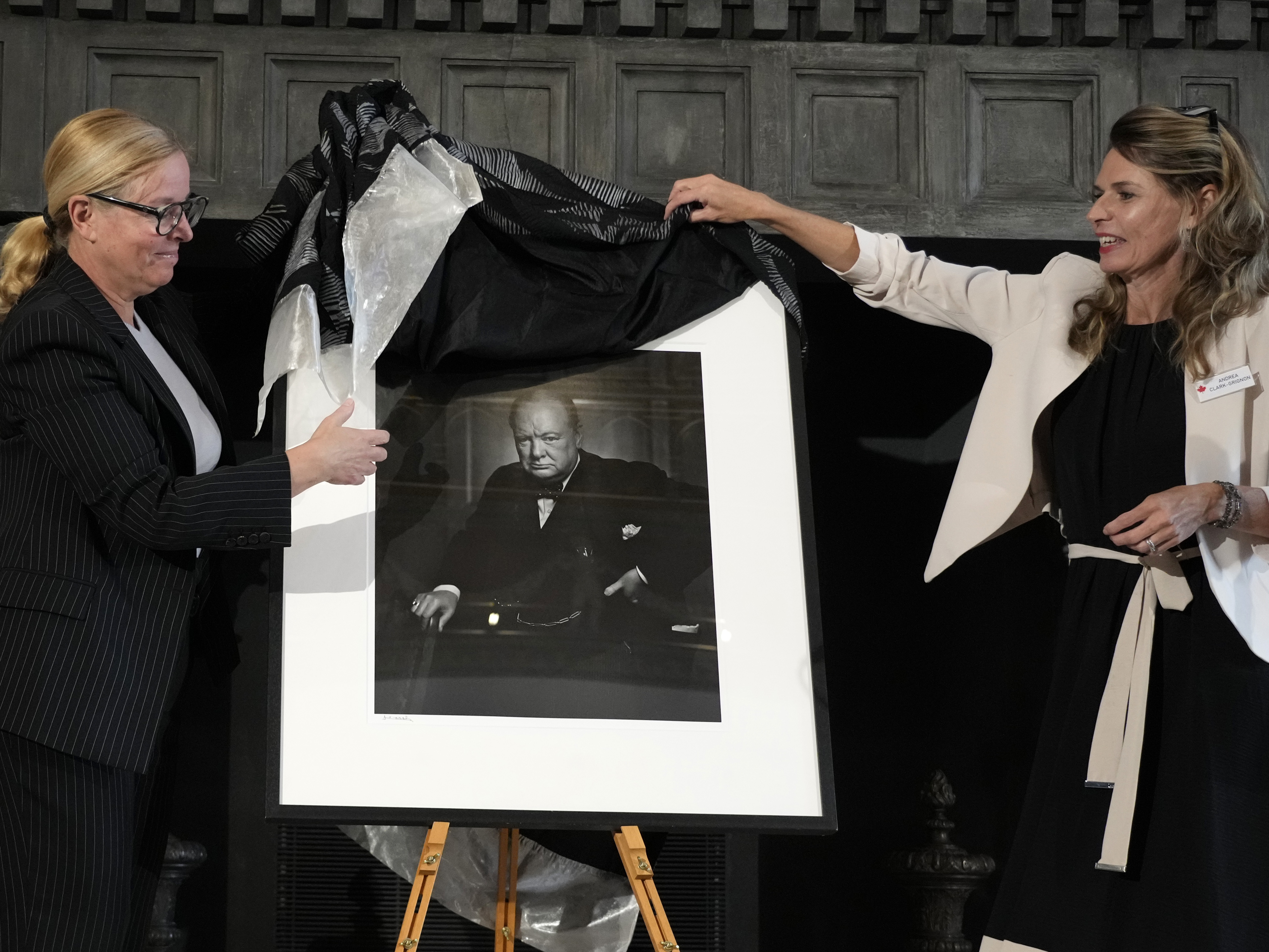 caption: Canadian Cultural Heritage Deputy Minister, Isabelle Mondou, left, and Andrea Clark-Grignon, Head of Public Affairs, unveil a photographic portrait known as 'The Roaring Lion', of Britain's Prime Minister Winston Churchill.