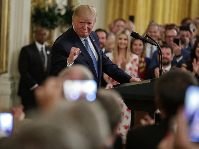 caption: President Trump speaks during an event on the environment Monday at the White House.