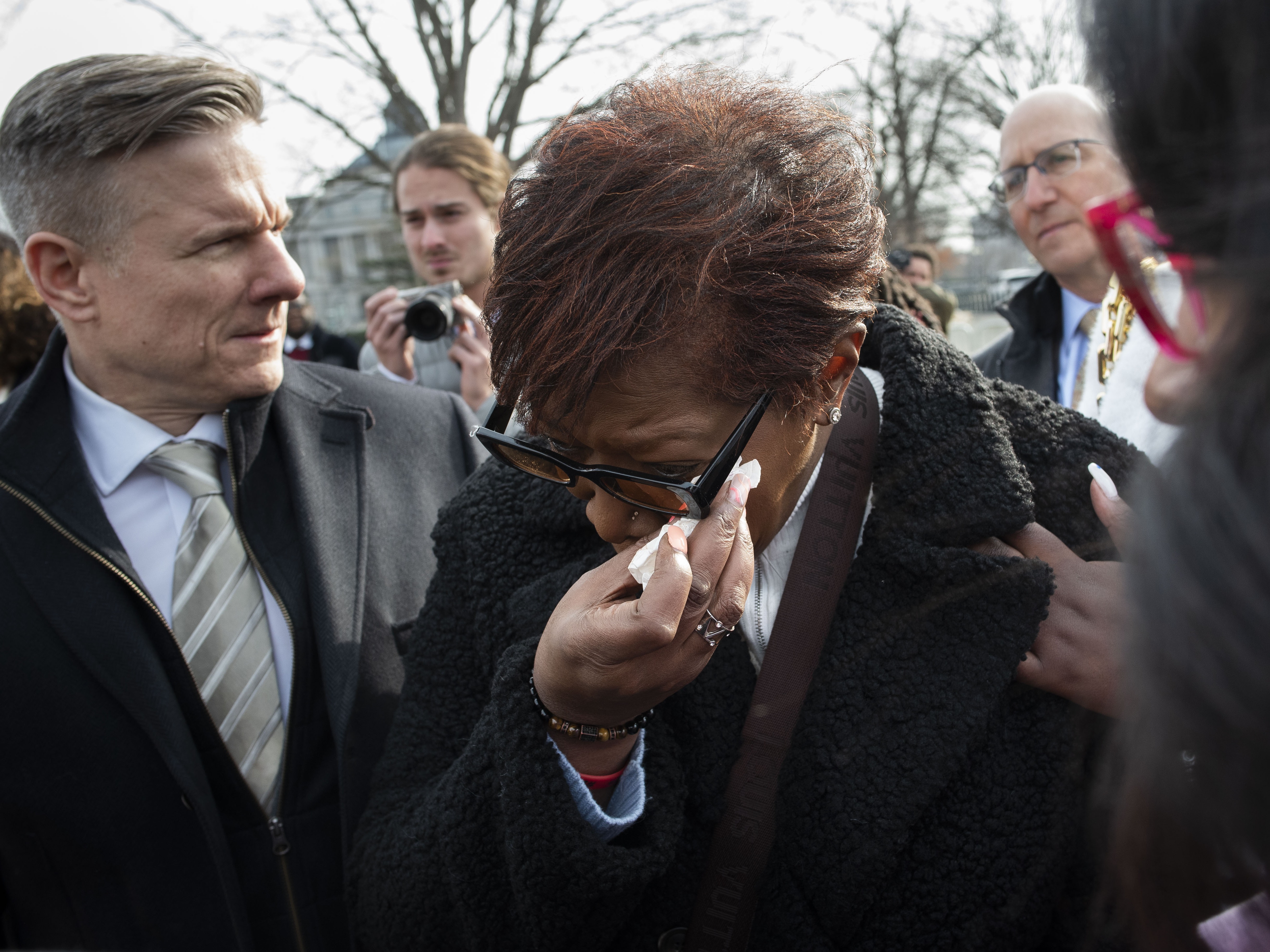 caption: Pamela Walker, mother of Jayland Walker, who was shot and killed by police in Akron, Ohio, is comforted prior to appearing before reporters about police reform, on Capitol Hill in Washington, on Feb. 7, 2023.