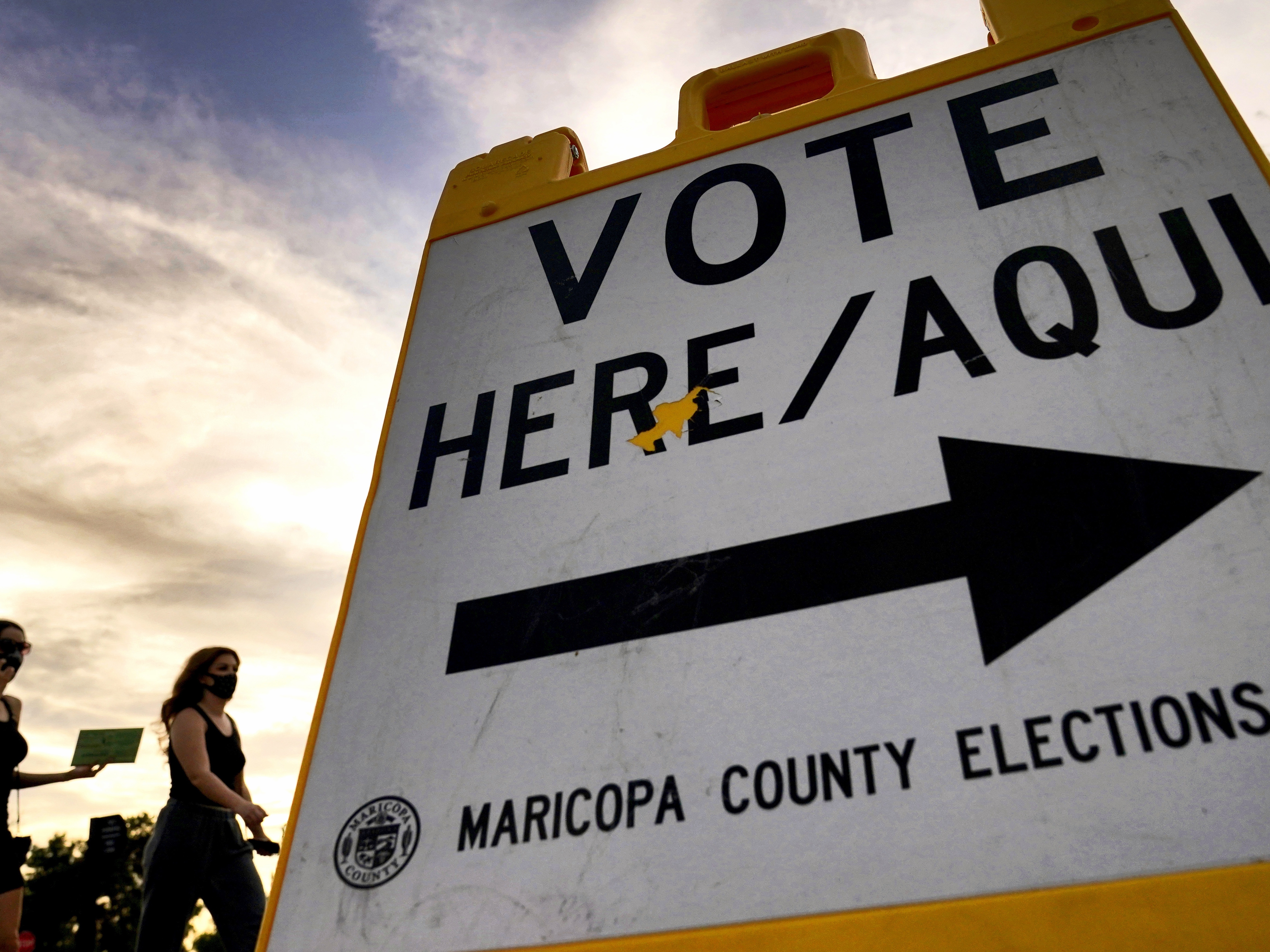 caption: Voters walk to a polling station in Tempe, Ariz., in November 2020.