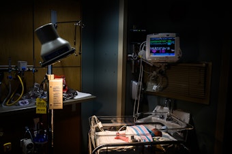 caption: Infants exposed to opioids in utero often experience symptoms of withdrawal. An infant is being monitored for opioid withdrawal inside a neonatal intensive care unit at the CAMC Women and Children's Hospital in June 2019, in Charleston, W.Va.