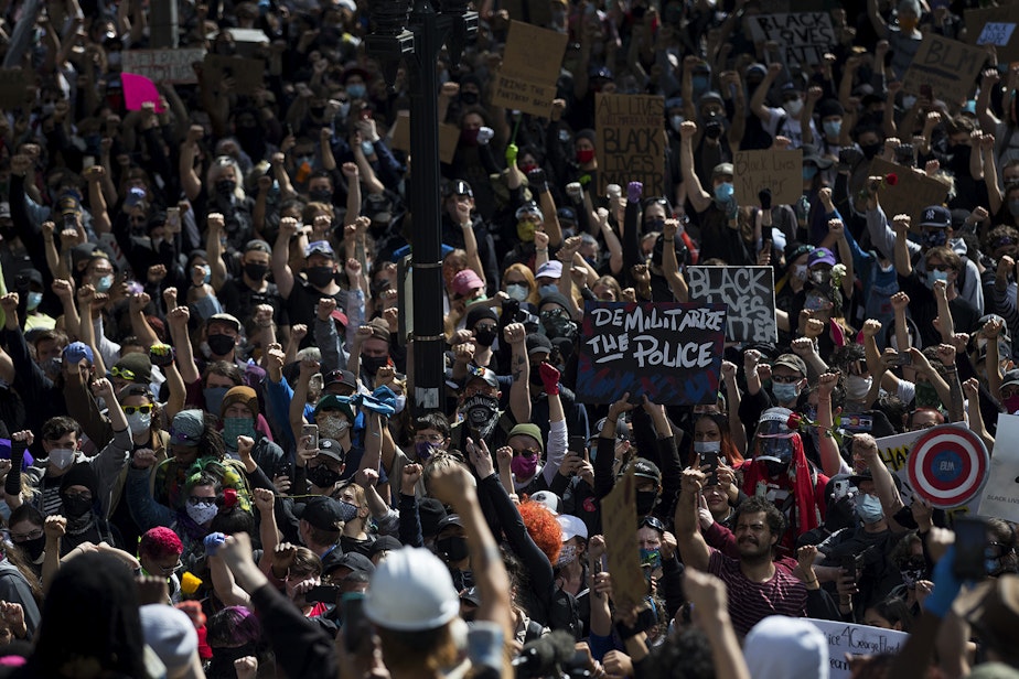 caption: Hundreds gather outside of Seattle City Hall during a peaceful protest march on Monday, June 1, 2020, in Seattle.
