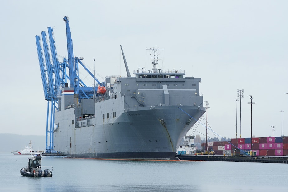 caption: The MV Cape Orlando is seen circled by U.S. Coast Guard and Tacoma police boats as protesters block the Port of Tacoma entrances to delay the loading of the vessel Monday, Nov. 6, 2023, in Tacoma, Wash. Hundreds of protesters calling for a cease-fire in Gaza are blocking traffic at the Port of Tacoma, where a military supply ship had recently arrived.