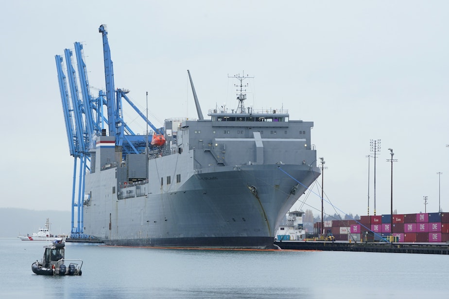 caption: The MV Cape Orlando is seen circled by U.S. Coast Guard and Tacoma police boats as protesters block the Port of Tacoma entrances to delay the loading of the vessel Monday, Nov. 6, 2023, in Tacoma, Wash. Hundreds of protesters calling for a cease-fire in Gaza are blocking traffic at the Port of Tacoma, where a military supply ship had recently arrived. 