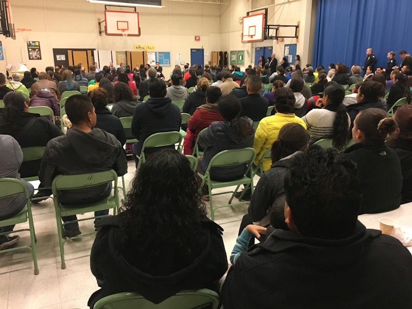 caption: Immigrants packed a gym in Bellevue on Thursday night to talk about Trump's immigration plan.