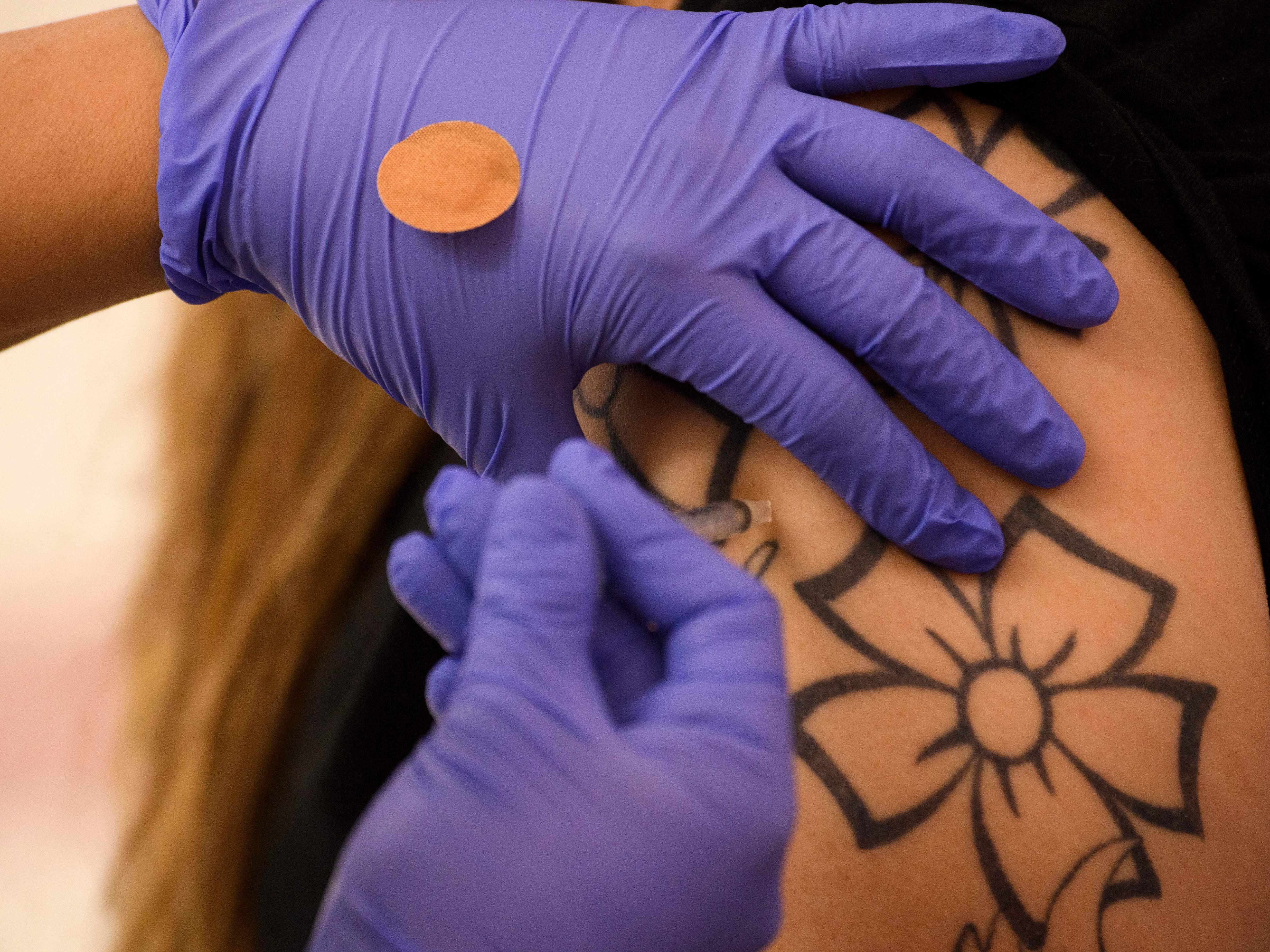 caption: An adult receives a dose of the Pfizer COVID-19 vaccine in May in Los Angeles. Full approval of the coronavirus vaccines would reassure the public they are safe, Dr. Leana Wen says.