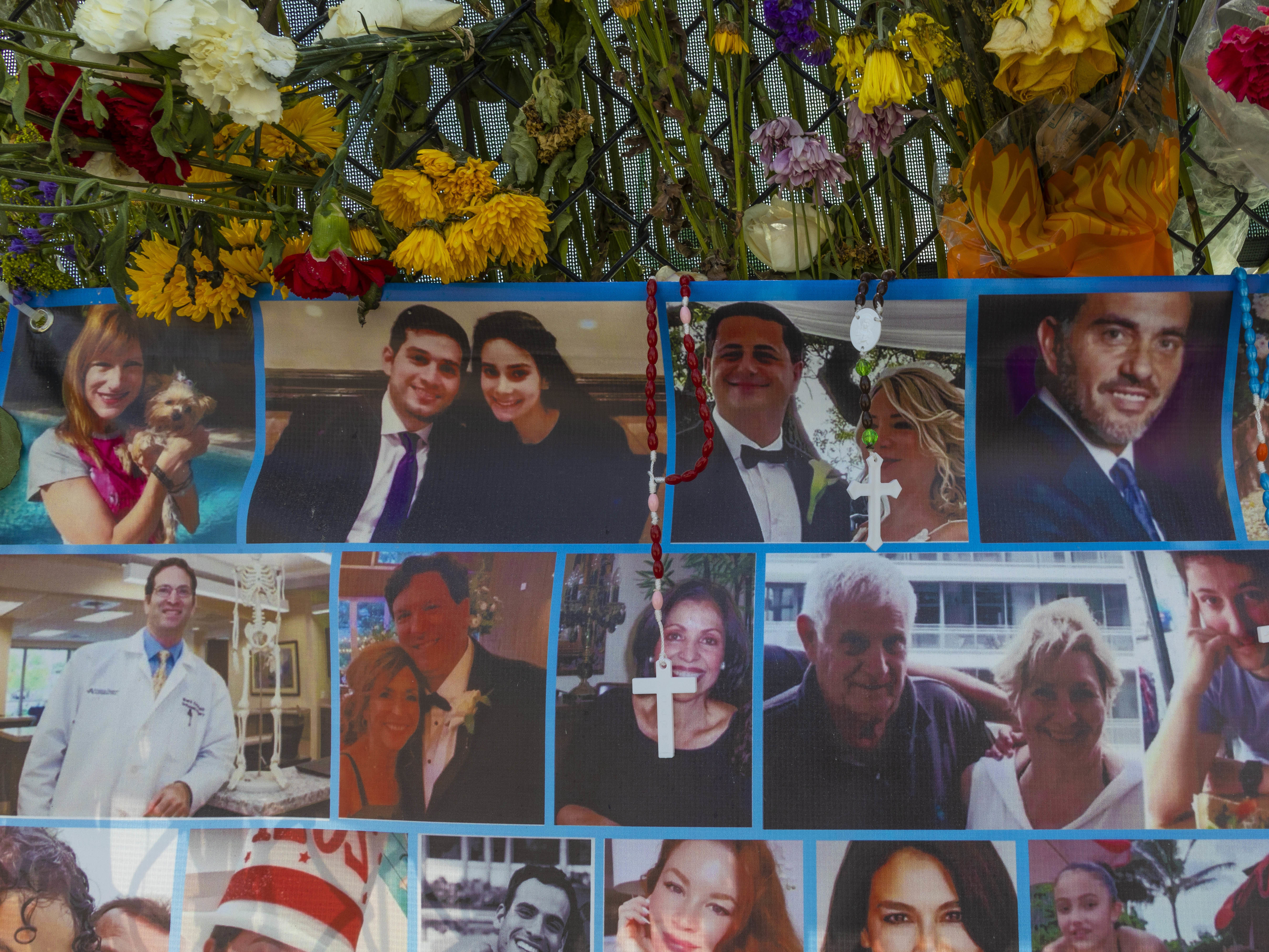 caption: A memorial shows some of the people still missing from the Champlain Towers South condo collapse in Surfside, Fla.