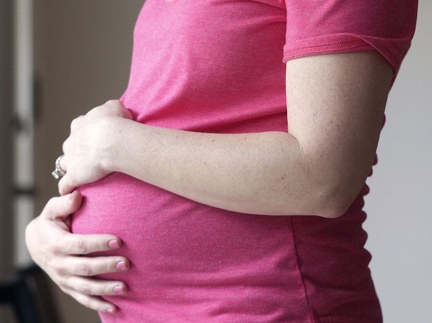 caption: A pregnant woman stands for a portrait in Dallas on May 18. A survey by the Centers for Disease Control and Prevention found that 20% of women reported experiences of mistreatment during maternal care.