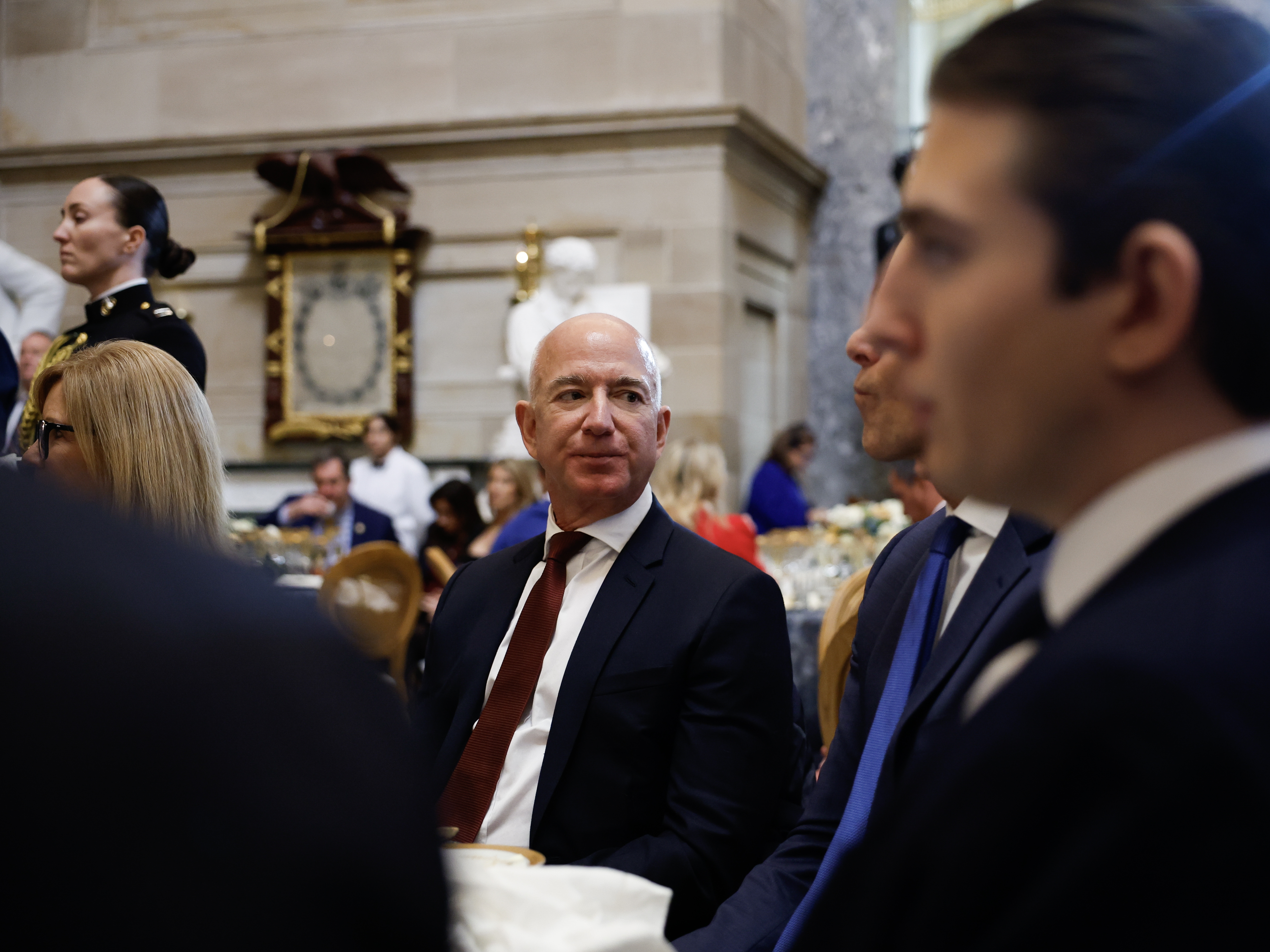 caption: <em>The Washington Post</em> owner Jeff Bezos attends a luncheon following the inauguration of President Trump in January. Bezos says the newspaper's editorial section will publish only "in support and defense of two pillars: personal liberties and free markets."