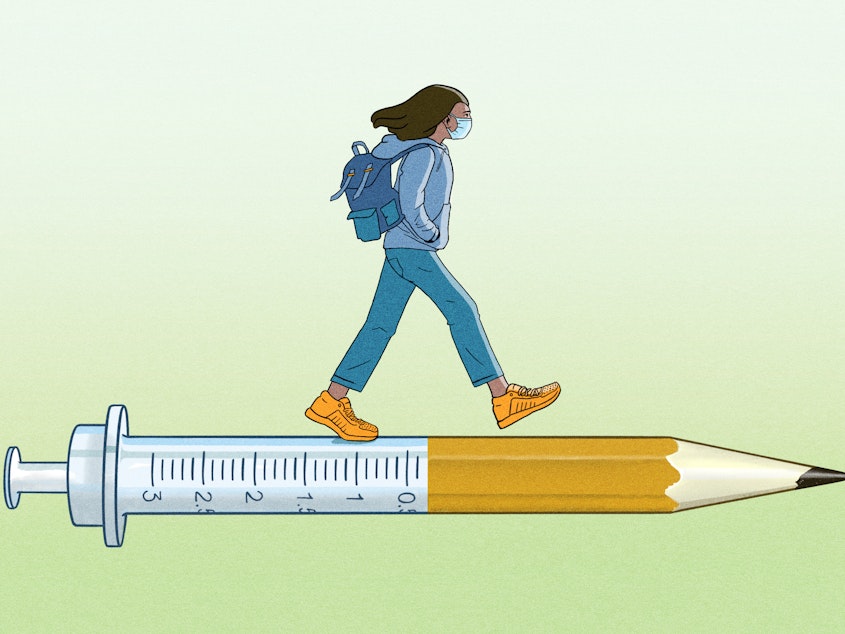 A masked college student walks along a syringe that morphs into a pencil.