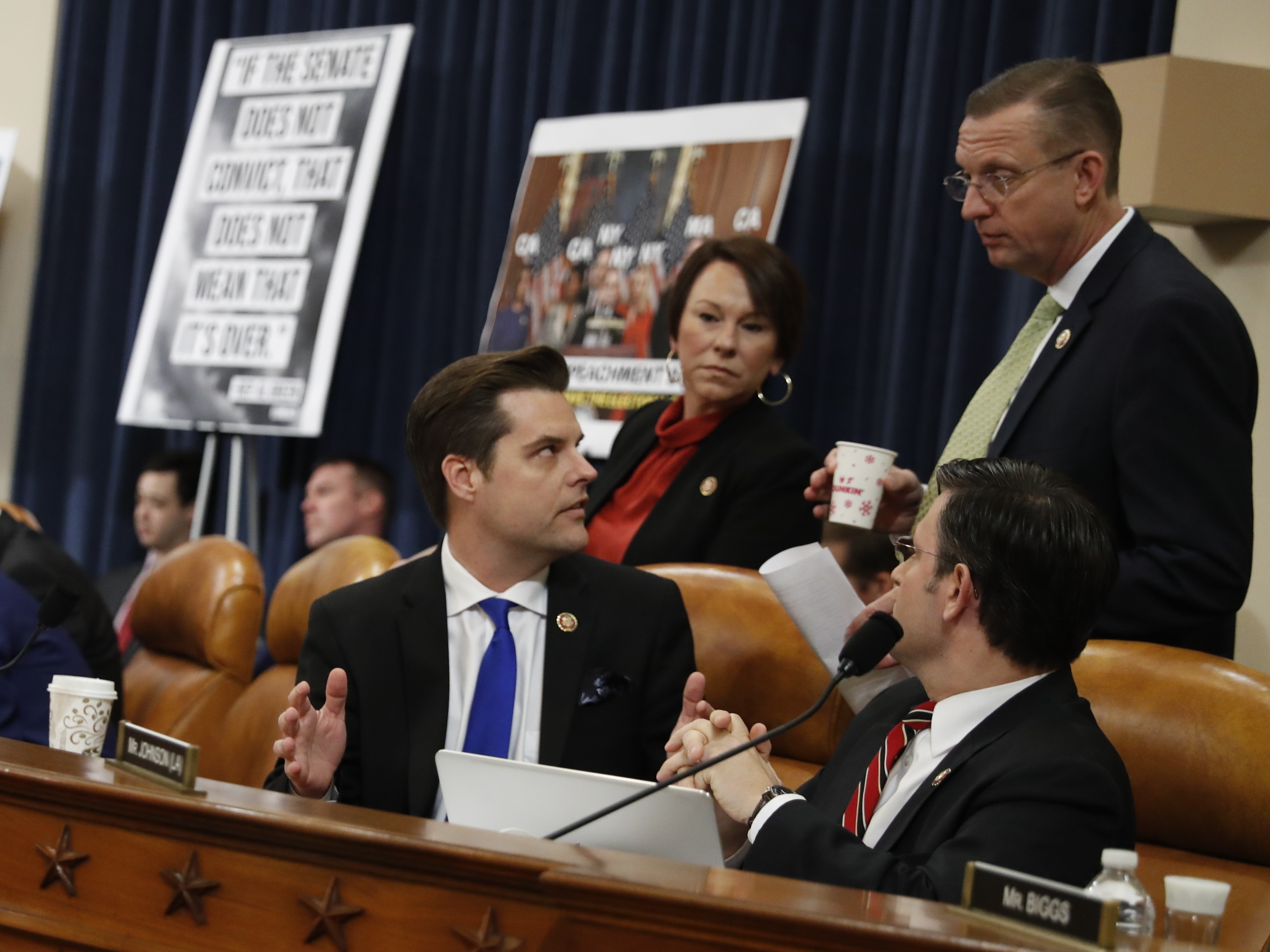 caption: Rep. Matt Gaetz, R-Fla., seated left center, talks Rep. Doug Collins, R-Ga., during a House Judiciary Committee markup in December. On Monday, both Gaetz and Collins said they were imposing self-quarantines after coming in contact with someone infected with coronavirus.