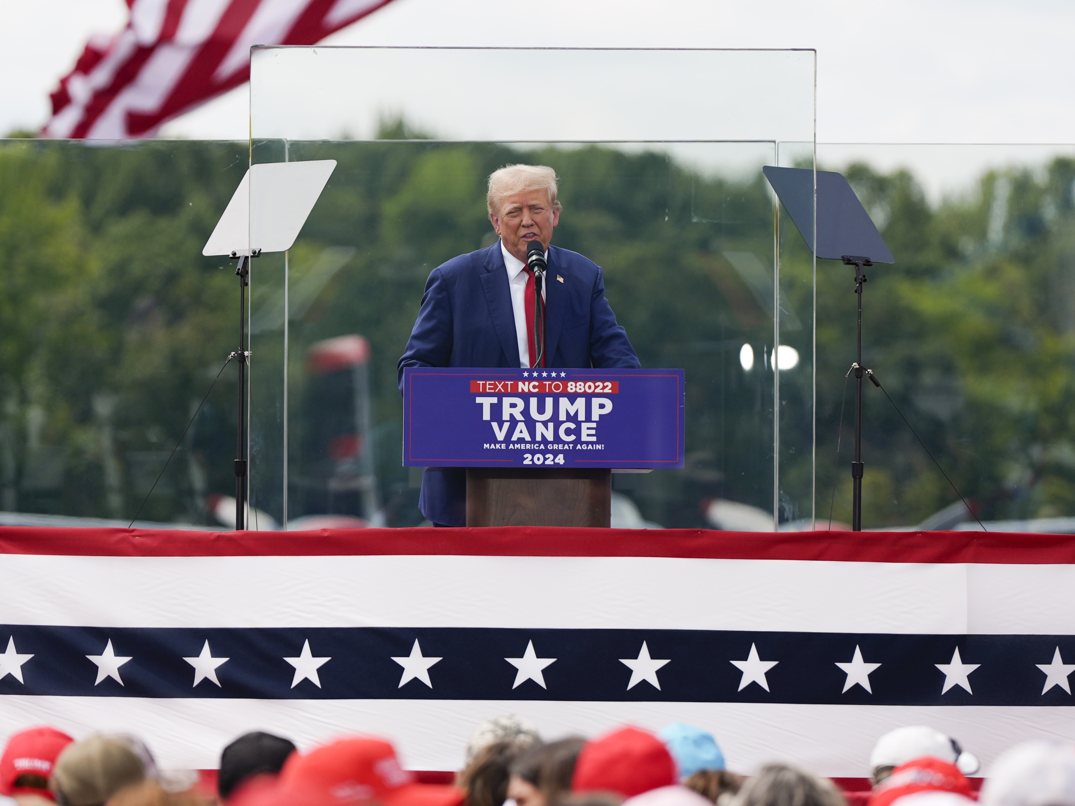 caption: Republican presidential nominee former President Donald Trump speaks during a campaign rally at North Carolina Aviation Museum on Wednesday in Asheboro, N.C. 