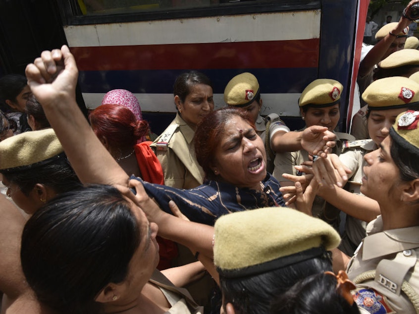 caption: Police detain women during a protest in front of the Supreme Court building in New Delhi in May. The demonstration was in response to Chief Justice Ranjan Gogoi's exoneration in a sexual harassment case.