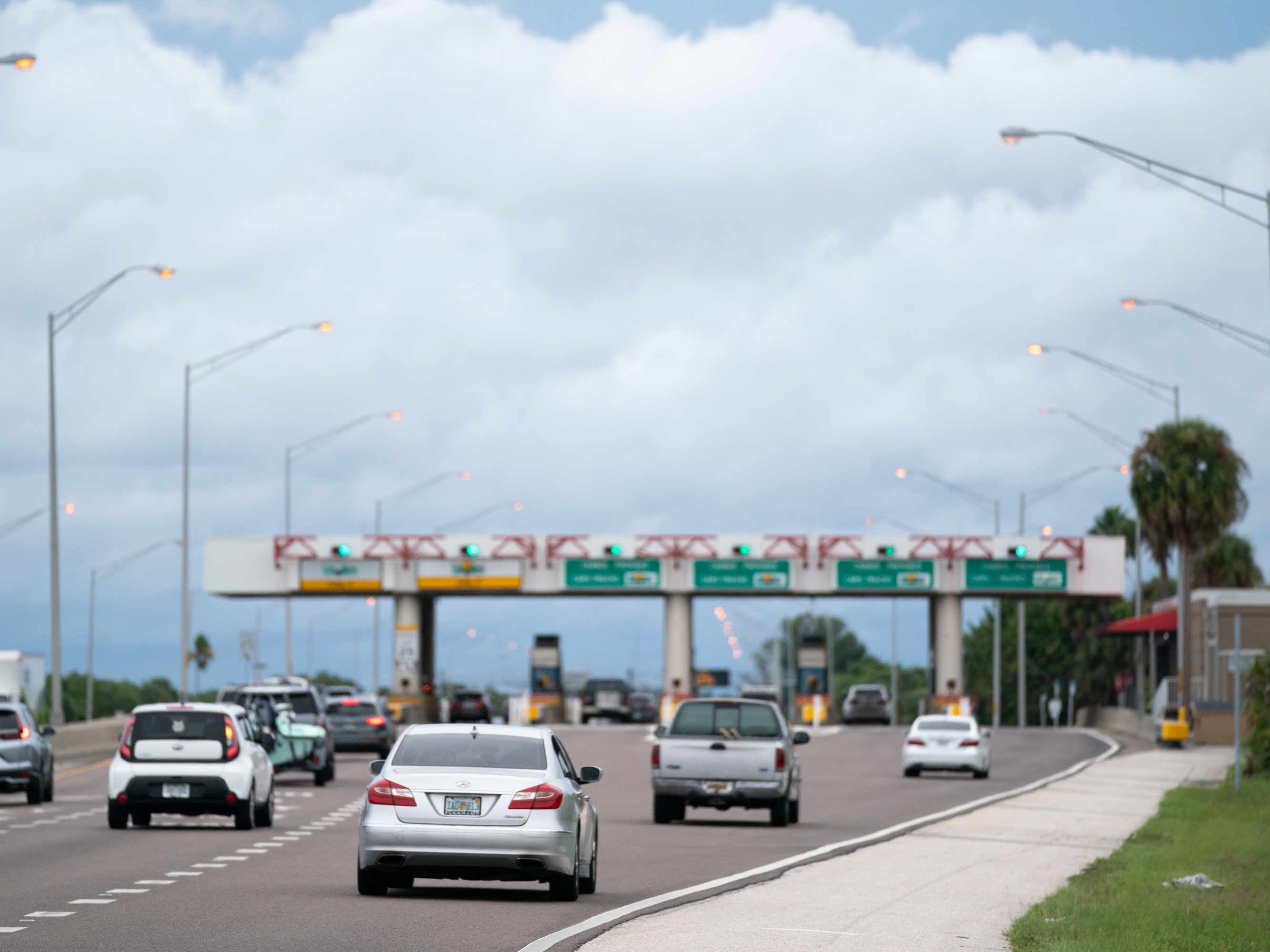caption: Motorists pass through a toll plaza near St. Petersburg, Florida. Bogus text messages threatening phone users with unpaid toll fees have spread rapidly — in part because scammers try to benefit from trends in travel and congestion pricing, an expert tells NPR.