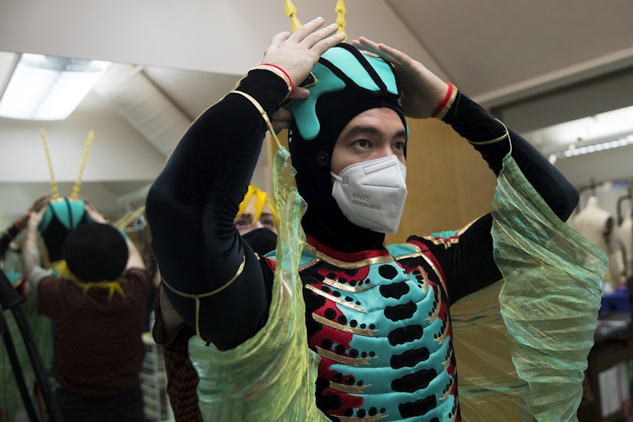 caption: Christian Poppe is fitted for his Cricket costume following a rehearsal for the Pacific Northwest Ballet's Nutcracker performance on Friday, November 19, 2021, in the costume shop at McCaw Hall in Seattle. KUOW Photo/Megan Farmer 