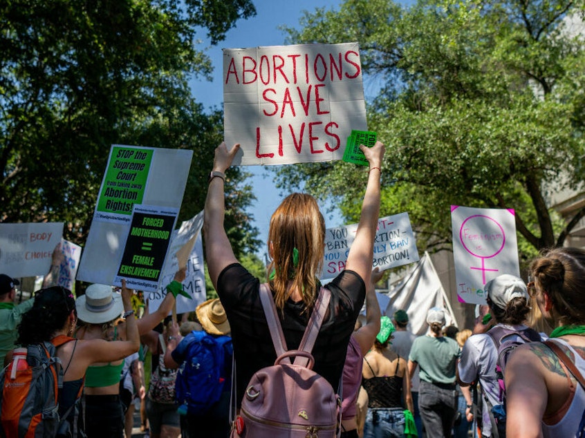 caption: Texas abortion rights supporters march near the Austin Convention Center in May of 2022. A new lawsuit filed in state court asks a judge to clarify medical exemptions in the state's abortion bans.