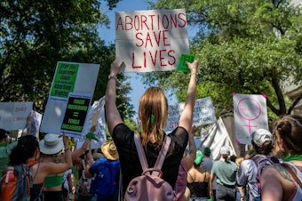 caption: Texas abortion rights supporters march near the Austin Convention Center in May of 2022. A new lawsuit filed in state court asks a judge to clarify medical exemptions in the state's abortion bans.