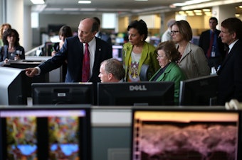 caption: NOAA's National Weather Service Director Louis Uccellini (L), gives a tour of NOAA's Center for Weather and Climate Prediction, to Commerce Secretary Penny Pritzker (2ndL), Sen. Barbara Mikulski (D-MD) (3rd-R), NOAA Acting Administrator Kathryn Sullivan (2nd-R), and Bryan Norcross (R),of the Weather Channel, , July 2, 2013 in Riverdale, Maryland.
