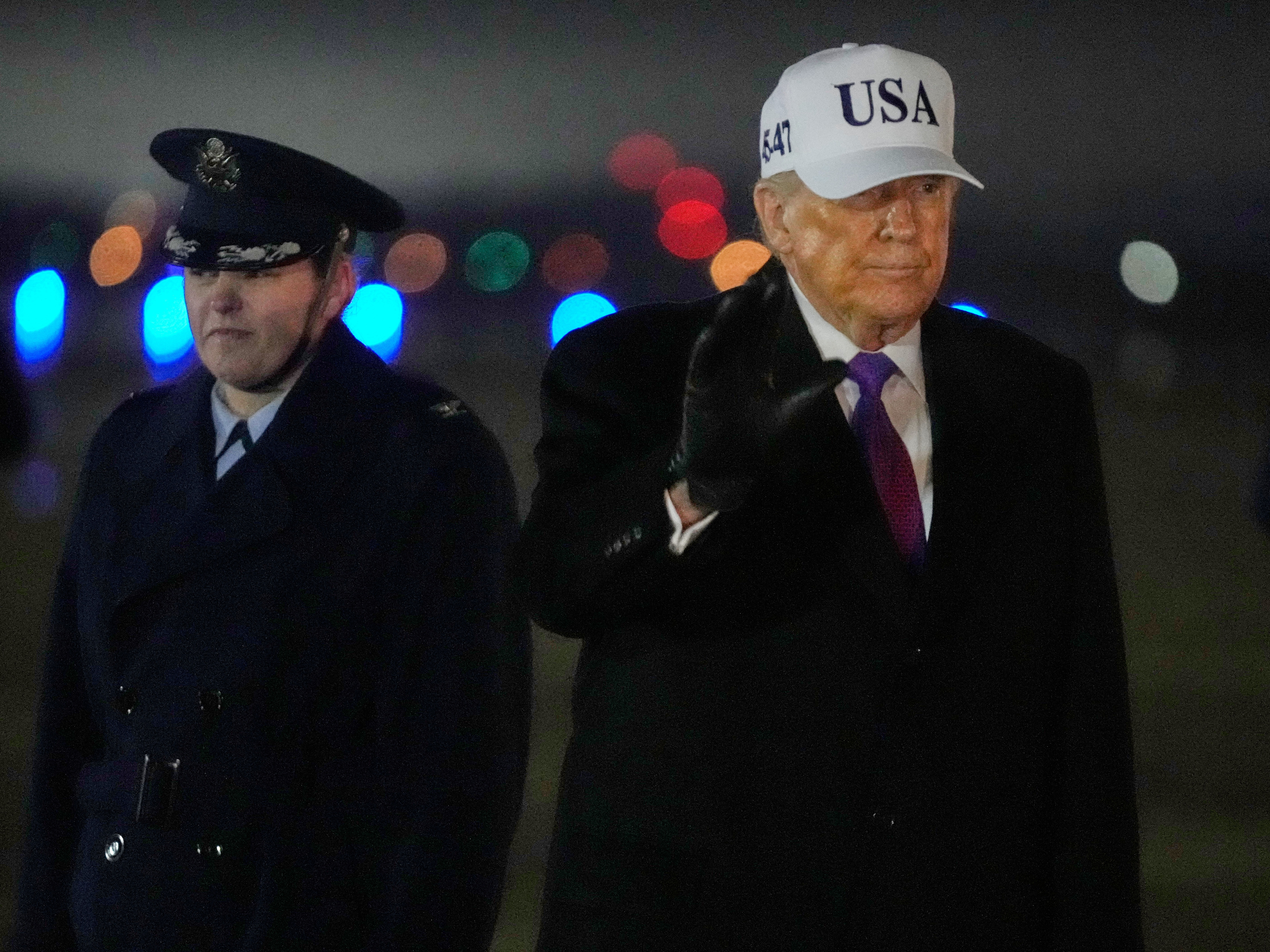 caption: President Donald Trump waves after stepping off Air Force One, Thursday, Feb. 19, 2026, at Joint Base Andrews, Md., on return from a trip to Georgia.