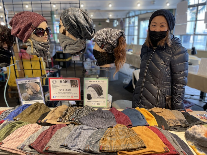 caption: Emmanuelle Shih sells "Grunge Beanies," also known as "Mobiis," at the Pike Place Market.