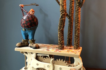 caption: Artist Don Becker creates automatons after being laid off from his job during the pandemic. This mechanical sculpture features a woodcutter being thwarted by trees.