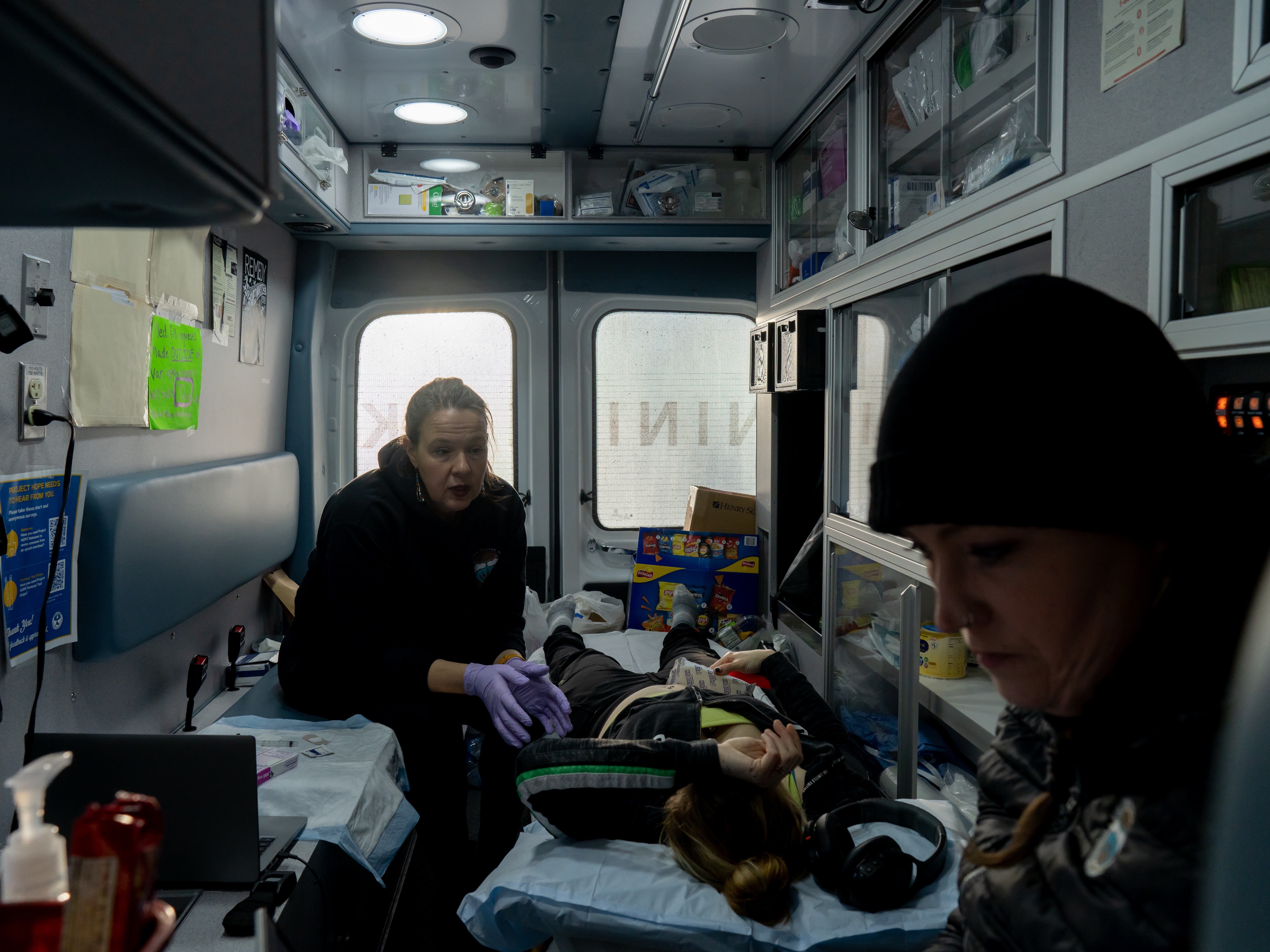 caption: Dr. Sarah Spencer and Case Manager Annette Hubbard see a patient in the mobile clinic outside of a shelter in Kenai, Alaska on November 20, 2025.