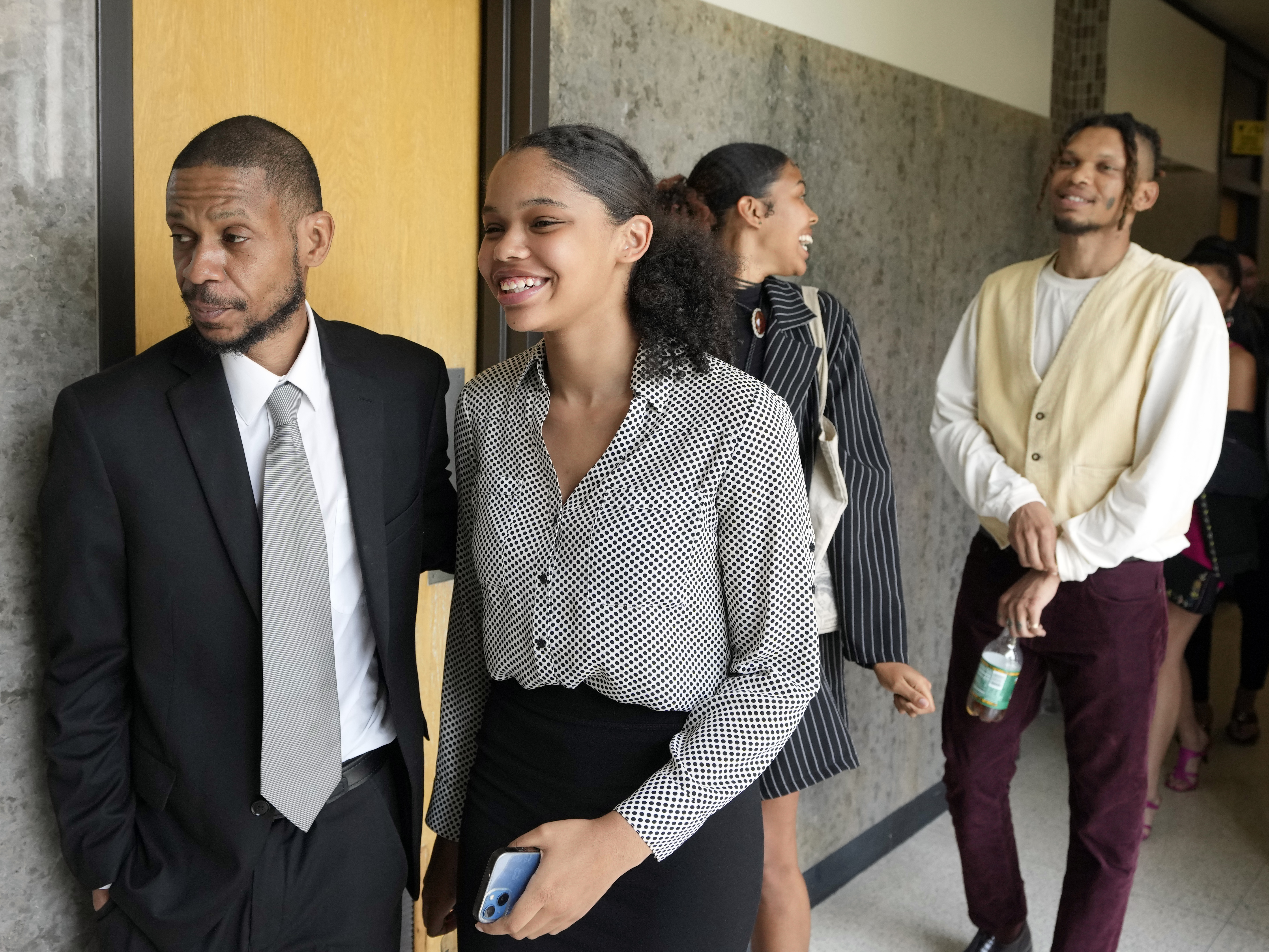 caption: Kecalf Franklin, a son of music superstar Aretha Franklin leaves a court hearing with his family on Tuesday in Pontiac, Mich. A document handwritten by singer Aretha Franklin and found in her couch after her 2018 death is a valid Michigan will, a jury said Tuesday, a critical turn in a dispute that has turned her sons against each other.