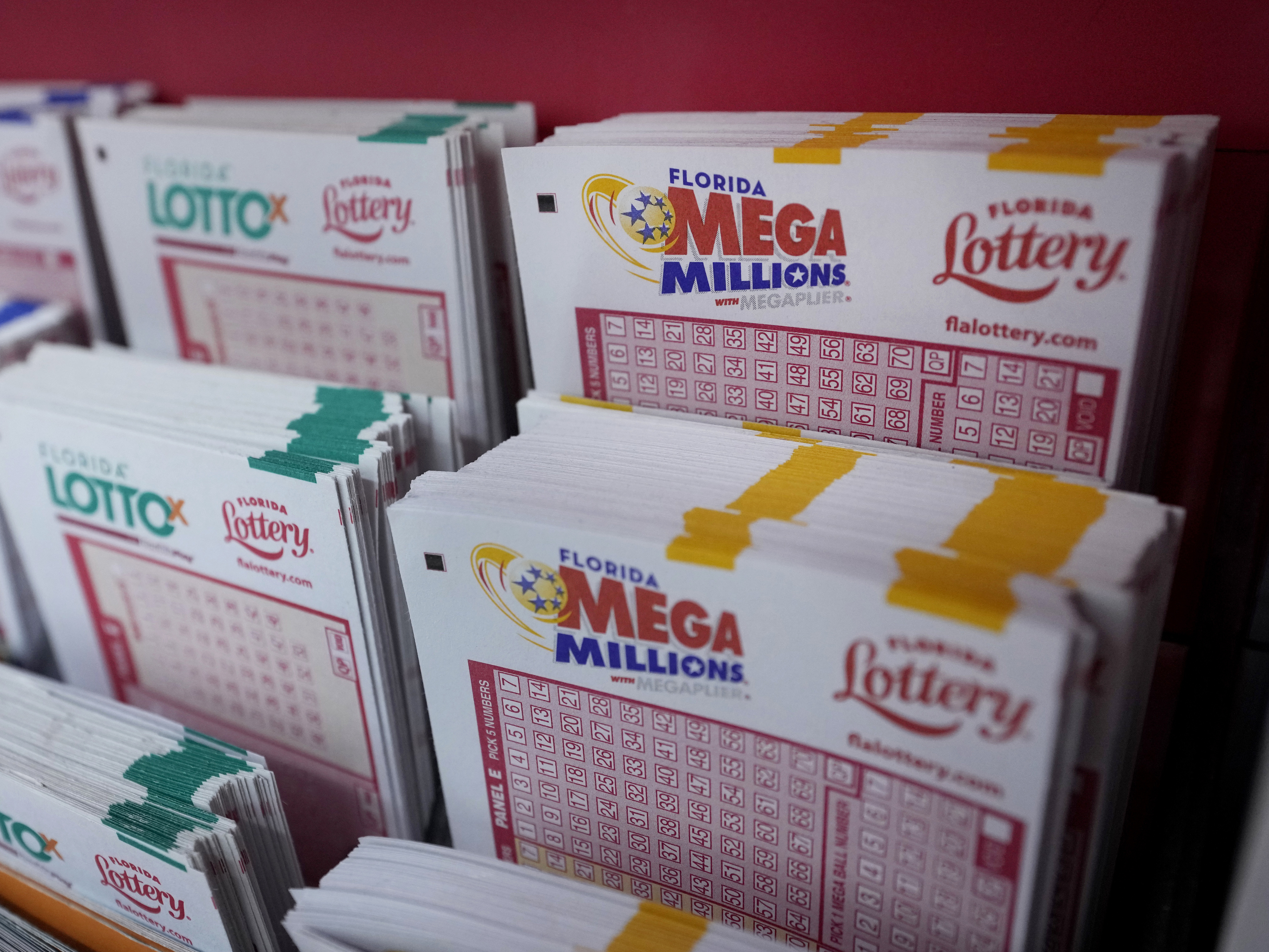 caption: Lottery forms are shown, Monday, Aug. 7, 2023, at the Presidente Supermarket in the Little Havana neighborhood of Miami. Mega Millions jackpot has grown to $1.55 billion, making it the third-largest ever ahead of Tuesday night's drawing.