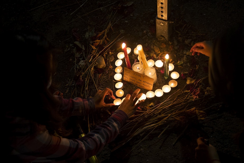 caption: Members of the Everyday March light candles and place them in the shape of a heart to honor John T. Williams, a First Nations wood carver who was unjustly shot and killed by Seattle Police in 2010, on Tuesday, August 4, 2020, near the home of Seattle City Councilmember Debora Juarez in Seattle. "It is on us," said TK, an organizer, to the crowd. "It is our duty, our obligation, our responsibility to come out here and stand up for the next generation."