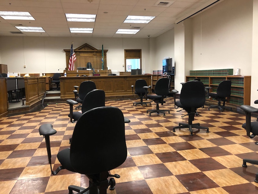 caption: A King County courtroom with socially distanced chairs for jurors. The pandemic slowed criminal trials and created a large backlog of cases. 