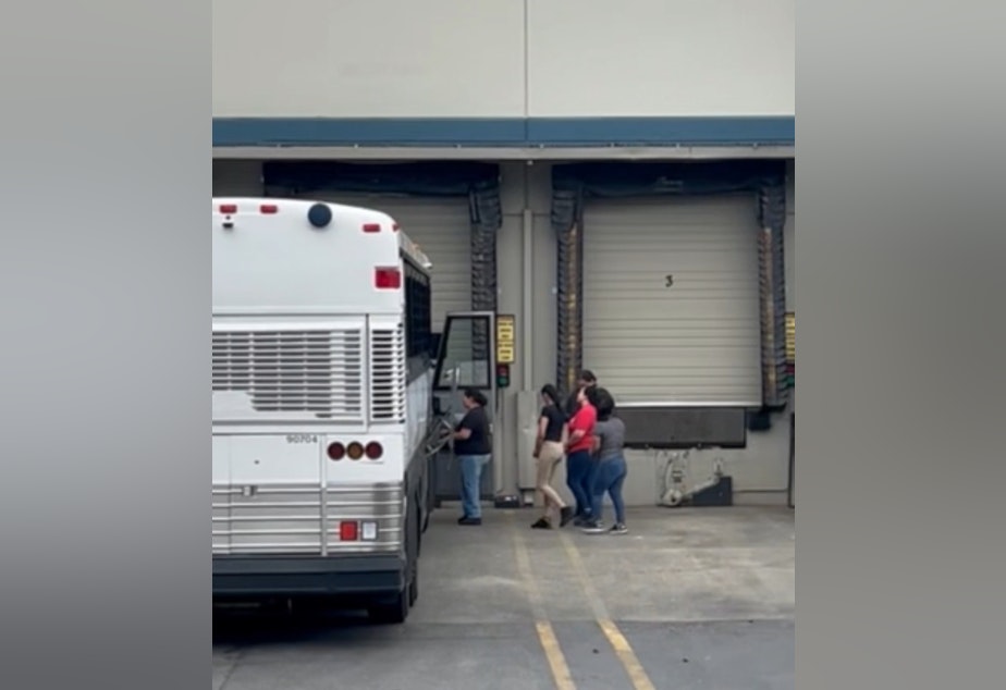 caption: Immigration agents arrest workers at a beverage factory in Kent on May 20, 2025.