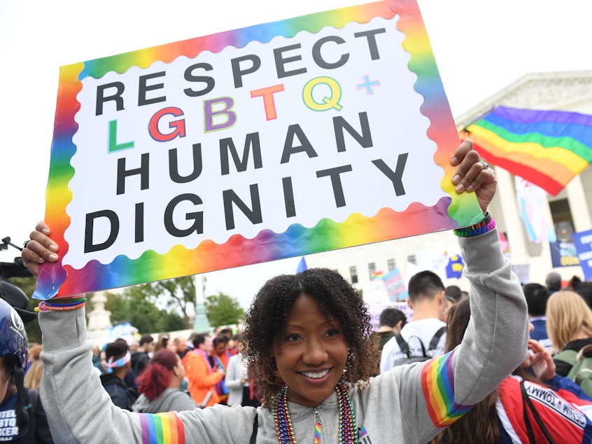 caption: A new report by GLAAD highlights the high rate of harassment and hate facing LGBTQ users on social media. In this photo, demonstrators rally in favor of LGBTQ rights outside the U.S. Supreme Court in Washington, D.C., in 2019.