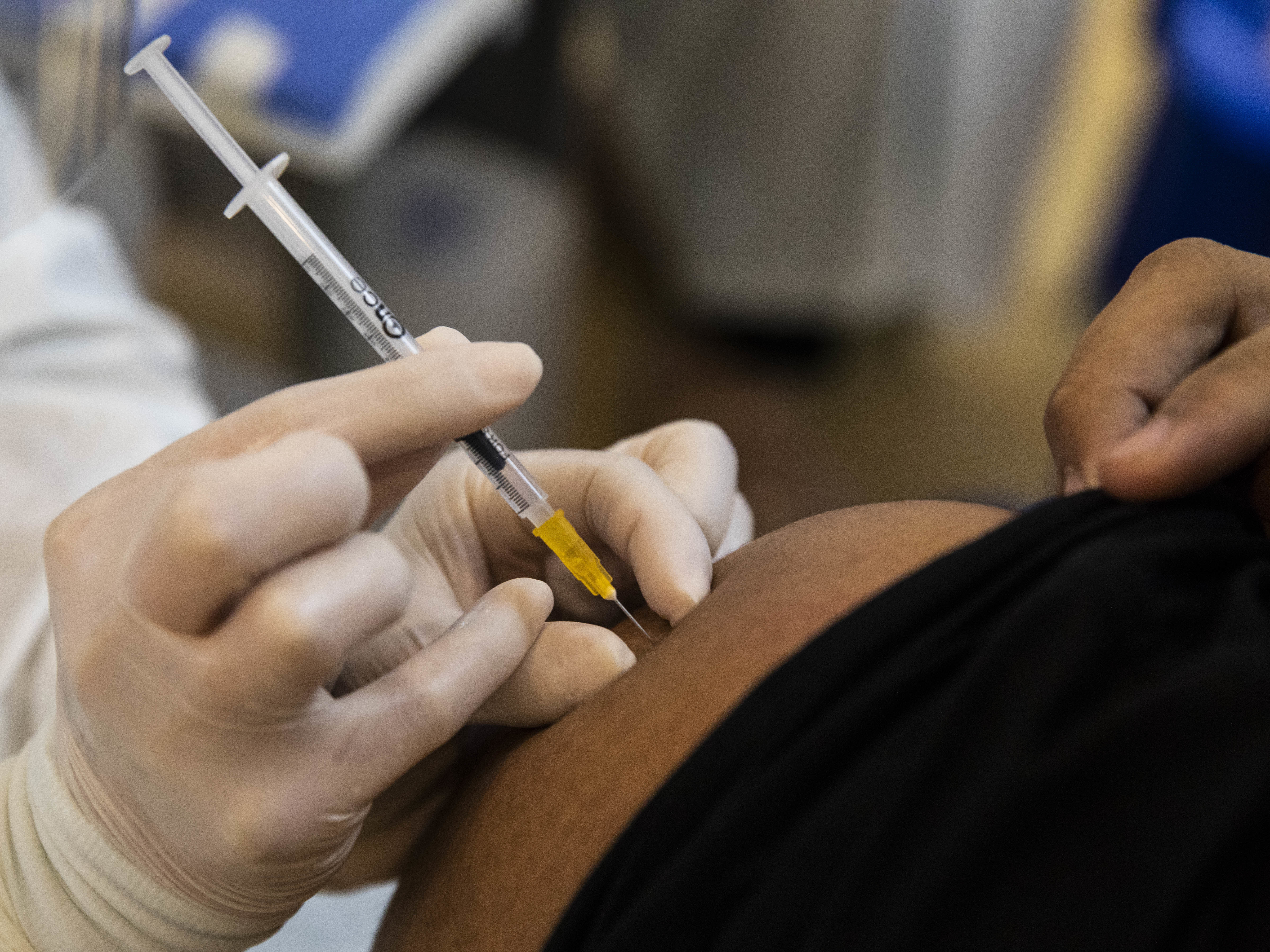 caption: A Thai teenager receives their first dose of the Pfizer-BioNTech COVID-19 vaccine Tuesday in Bangkok. President Biden is set to announce on Wednesday that the U.S. is buying 500 million more doses of the Pfizer vaccine to donate to countries.