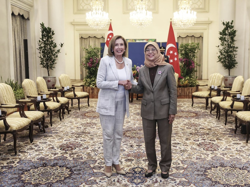 caption: In this photo provided by the Ministry of Communications and Information, Singapore, U.S. House Speaker Nancy Pelosi, left, and Singapore President Halimah Yacob shake hands at the Istana Presidential Palace in Singapore, Monday, Aug. 1, 2022.
